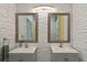 Modern bathroom with double vanity sinks, framed mirrors, decorative towel rack, and textured wall paneling at 826 Sheen Cir Cir, Haines City, FL 33844