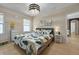 Cozy bedroom featuring a comfy bed with leafy patterned bedding, and a bedside table with a lamp at 826 Sheen Cir Cir, Haines City, FL 33844