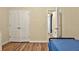 Bedroom featuring wood floors, a full-size bed and doors leading to other rooms at 826 Sheen Cir Cir, Haines City, FL 33844