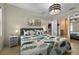 Comfortable bedroom featuring modern decor, leafy-themed bedding, and a view through to the kitchen at 826 Sheen Cir Cir, Haines City, FL 33844