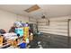 Spacious garage featuring ample storage, including overhead storage and a refrigerator for convenience at 826 Sheen Cir Cir, Haines City, FL 33844