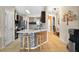 Open kitchen featuring an island with bar seating, stainless steel appliances, and stylish backsplash at 826 Sheen Cir Cir, Haines City, FL 33844