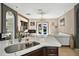 Open-concept kitchen with a sink with a large countertop and view of the living room and backyard at 826 Sheen Cir Cir, Haines City, FL 33844