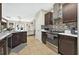 Modern kitchen featuring stainless steel appliances, dark wood cabinets, and an open layout connected to the living area at 826 Sheen Cir Cir, Haines City, FL 33844