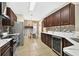 Well-equipped kitchen with stainless steel appliances, wine fridge, marble countertops, and a breakfast nook at 826 Sheen Cir Cir, Haines City, FL 33844