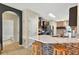 Modern kitchen with a marble countertop island, barstools, stainless steel appliances, and mosaic tile accents at 826 Sheen Cir Cir, Haines City, FL 33844