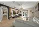 Cozy living room with a view of the patio, white sofa, and a large screen tv at 826 Sheen Cir Cir, Haines City, FL 33844