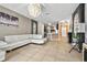 Bright living room featuring a modern sofa, decorative lighting, and tile flooring at 826 Sheen Cir Cir, Haines City, FL 33844