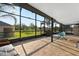 Large screened patio features travertine tile and views of the spacious backyard at 826 Sheen Cir Cir, Haines City, FL 33844