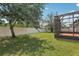 A large, green backyard with a screened-in patio, providing ample space for recreation and leisure at 827 Timber Isle Dr, Orlando, FL 32828