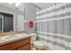 A clean bathroom with a combination shower and tub, featuring a wood vanity and neutral color palette at 827 Timber Isle Dr, Orlando, FL 32828