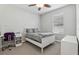 Neutral bedroom featuring a bed, desk, and natural light at 827 Timber Isle Dr, Orlando, FL 32828