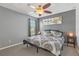 A cozy bedroom with a ceiling fan, stylish decor, and plenty of natural light creates a relaxing retreat at 827 Timber Isle Dr, Orlando, FL 32828