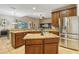 Spacious kitchen features granite countertops, wooden cabinets, stainless steel appliances, and open layout at 827 Timber Isle Dr, Orlando, FL 32828