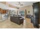 Open-concept living room with tile flooring, a ceiling fan, and a large sectional sofa at 827 Timber Isle Dr, Orlando, FL 32828
