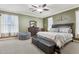 Serene main bedroom displaying soft green walls, neutral carpet, and a decorative ceiling fan at 827 Timber Isle Dr, Orlando, FL 32828