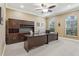 Spacious home office featuring custom built-ins, two desks, and natural light from arched windows at 827 Timber Isle Dr, Orlando, FL 32828