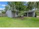 Side view of a grey home with a well manicured lawn and covered porch at 885 Little Bend Rd, Altamonte Springs, FL 32714