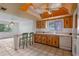 View of the kitchen with tiled floors, wood cabinets, and connection to the dining room at 885 Little Bend Rd, Altamonte Springs, FL 32714