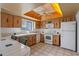 A bright kitchen featuring white appliances, wood cabinets, and tile countertops at 885 Little Bend Rd, Altamonte Springs, FL 32714