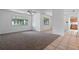 Spacious living room featuring neutral carpet, an open layout, and two windows at 885 Little Bend Rd, Altamonte Springs, FL 32714