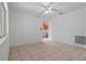 Bright living room with tile flooring, ceiling fan, and view into the kitchen at 885 Little Bend Rd, Altamonte Springs, FL 32714