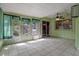 Enclosed back porch, tiled with green walls and multiple windows at 885 Little Bend Rd, Altamonte Springs, FL 32714