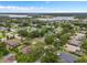 Aerial view of the neighborhood and homes with lake in the distance at 11648 Grand Bay Blvd, Clermont, FL 34711