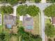 Aerial view of property showing screened pool, patio, backyard, and proximity to neighborhood at 11648 Grand Bay Blvd, Clermont, FL 34711