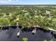 Aerial view of a lakefront community with docks, a boat house, and lake access at 11648 Grand Bay Blvd, Clermont, FL 34711