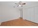 Bedroom with wood floors, closet, ceiling fan, and entry to the hallway at 11648 Grand Bay Blvd, Clermont, FL 34711