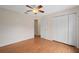 Bedroom with ceiling fan, wood floors and closet with views to the entry hallway at 11648 Grand Bay Blvd, Clermont, FL 34711