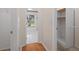 Hallway with closet leading to bathroom with tiled floor and view of the front yard at 11648 Grand Bay Blvd, Clermont, FL 34711