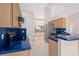 Bright kitchen with stainless steel appliances, blue countertops, and an open floorplan at 11648 Grand Bay Blvd, Clermont, FL 34711