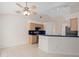 Open kitchen featuring tile floors, wood cabinets, and a breakfast bar at 11648 Grand Bay Blvd, Clermont, FL 34711
