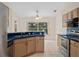 Bright kitchen with stainless steel appliances, blue countertops, and a view to the backyard at 11648 Grand Bay Blvd, Clermont, FL 34711