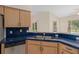 Bright kitchen with stainless steel appliances, blue countertops, and a view to the pool at 11648 Grand Bay Blvd, Clermont, FL 34711