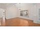 Open living room featuring vaulted ceilings, a large window, and wood-look flooring at 11648 Grand Bay Blvd, Clermont, FL 34711