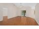 Relaxing living room boasting wood floors and slider door with views of the pool area at 11648 Grand Bay Blvd, Clermont, FL 34711