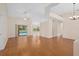 Spacious living room showcasing beautiful wood floors and sliding doors to the pool area at 11648 Grand Bay Blvd, Clermont, FL 34711