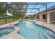 An inviting screened-in pool and spa offer a private outdoor retreat at 11648 Grand Bay Blvd, Clermont, FL 34711