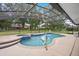Relaxing screened-in pool with adjacent spa and large deck surrounded by mature trees at 11648 Grand Bay Blvd, Clermont, FL 34711