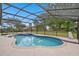 A beautiful screened-in pool and spa are surrounded by a spacious concrete deck at 11648 Grand Bay Blvd, Clermont, FL 34711