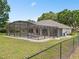 Enclosed pool area with screened lanai, patio, and backyard at 11648 Grand Bay Blvd, Clermont, FL 34711