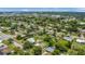 Aerial shot of the home situated in a neighborhood, surrounded by lush greenery and featuring a spacious, fenced-in backyard at 1208 Baltimore Dr, Orlando, FL 32810
