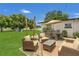 Backyard with patio set, outdoor seating, green grass, and landscaping at 1208 Baltimore Dr, Orlando, FL 32810