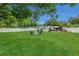 Expansive backyard featuring lush green grass, white fencing, and inviting seating areas for relaxing or entertaining at 1208 Baltimore Dr, Orlando, FL 32810