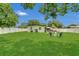 Lush backyard featuring a well-maintained lawn and multiple seating areas, perfect for outdoor gatherings and relaxation at 1208 Baltimore Dr, Orlando, FL 32810