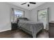 This bedroom features neutral walls, wood floors, and large windows that let in natural light at 1208 Baltimore Dr, Orlando, FL 32810