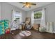 Bedroom with wood floors, a baseball rug, and natural lighting shining through its large windows at 1208 Baltimore Dr, Orlando, FL 32810